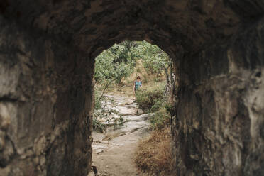 Mid adult woman walking in forest during weekend - MRRF01415