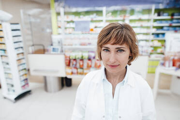 Smiling female professional at pharmacy - JOSEF05411