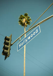 USA, California, City of Los Angeles, Stoplight with Hollywood sign hanging against clear turquoise sky - AJOF01649