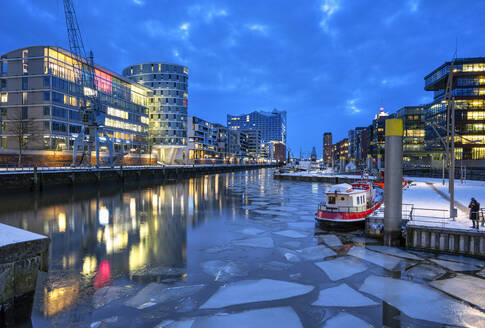Deutschland, Hamburg, Eisschwimmen im HafenCity-Kanal in der frühen Morgendämmerung - RJF00874