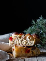 Close up of one piece of fresh tomato focaccia with rosemary - ADSF29918