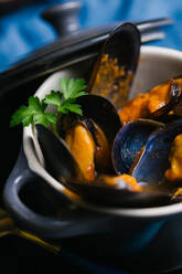 Delectable mussels with herbs in metal saucepan - ADSF29925