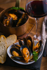 Delectable mussels with herbs in bowl - ADSF29926