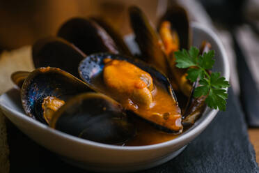 Delectable mussels with herbs in bowl - ADSF29927