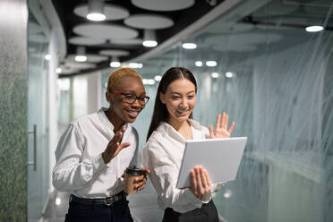 Happy multiethnic businesswomen making video call - CAVF94675