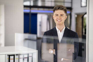 Handsome businessman with arms crossed in office - PESF03200