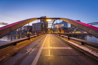 Germany, Hamburg, Niederbaumbrecke at dawn with city skyline in background - RJF00888