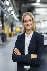 Female manger standing with arms crossed at industry - DIGF16477