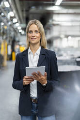 Female professional with digital tablet at industry - DIGF16480