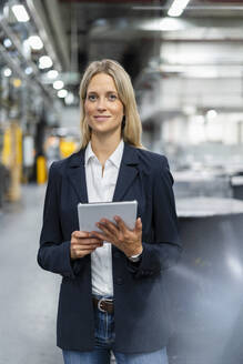 Female professional with digital tablet at industry - DIGF16480