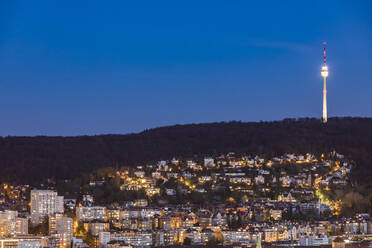 Germany, Baden-Wurttemberg, Stuttgart, Clear sky over city suburb at dusk with television tower in background - WDF06607