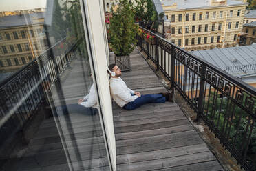 Businessman relaxing in office balcony - VPIF04761