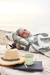 Mature man lying on beach - VEGF04968