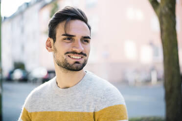 Handsome young man with hair stubble at park - MOEF03938