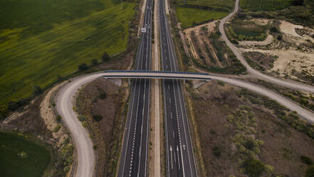 Aerial view of overpass stretching over countryside highway - ACPF01304