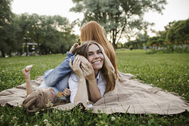 Mother having fun with daughter at park - LLUF00056