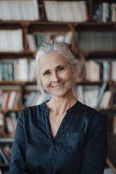 Smiling businesswoman with gray hair in cafe - JOSEF05822