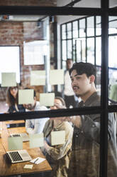 Businessman explaining colleagues during meeting at startup company - MASF25187