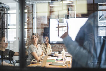 Male and female entrepreneurs discussing during meeting in board room - MASF25198