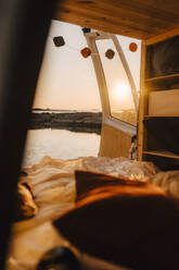 Interior of motor home at lakeshore during sunset - MASF25344