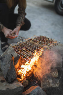 Low section of man preparing food during camping - MASF25645