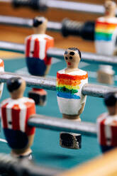 Detailaufnahme eines Retro-Tischfußballs mit hölzernen Miniaturfiguren von Spielern auf Metallstangen - ADSF29977