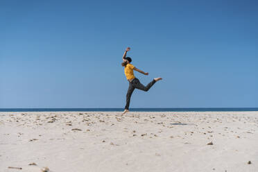 Carefree man running on beach - AFVF09189