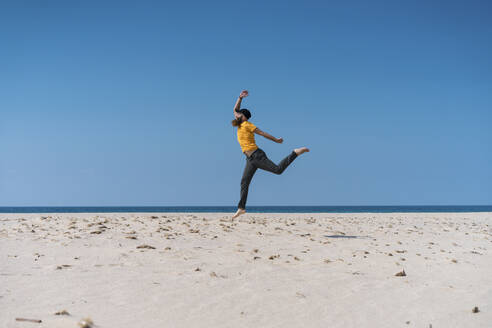 Carefree man running on beach - AFVF09189