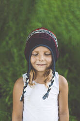 Cute girl with wearing knit hat standing with eyes closed - OMIF00067