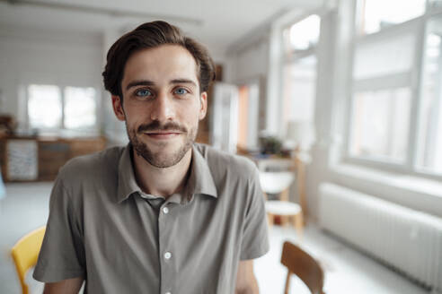 Young man with stubble at home - KNSF08968