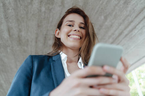 Female professional with mobile phone in basement - GUSF06497