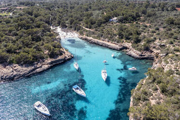 Spain, Balearic Islands, Mallorca, Aerial view of boats floating in blue bay of Cala Sa Nau - AMF09264