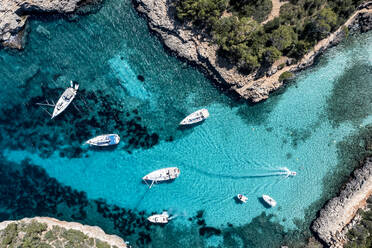 Spain, Balearic Islands, Mallorca, Aerial view of boats floating in blue bay of Cala Sa Nau - AMF09266