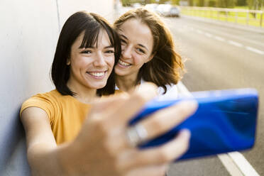 Lesbisches Paar nimmt Selfie durch Mobiltelefon - GIOF13556