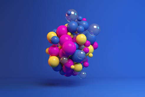 Three dimensional render of colorful spheres floating against blue background - JPSF00247