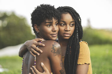 Junges lesbisches Paar umarmt sich im Park - JCCMF03923