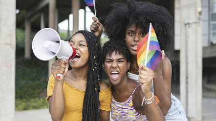 Lesbian women with pride flag screaming during protest - JCCMF03945