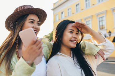 Smiling woman standing arm around with female friend - OYF00523