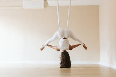 Flexible Turnerin beim Dehnen in einem Yoga-Studio - OCAF00780