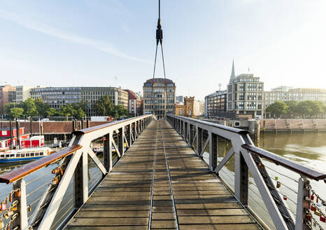 Germany, Hamburg, Hafenbrucke bridge in Binnenhafen with Speicherstadt district in background - IHF00496
