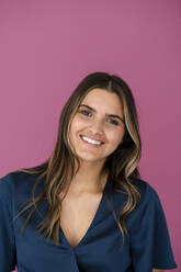 Young businesswoman in front of pink color wall - KNSF09174