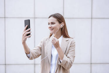 Female business professional attending video call through smart phone - EBBF04745