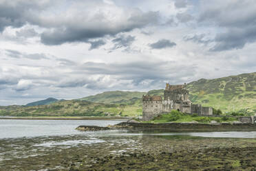 Eilan Donan, a remote castle on a tidal island with low tide. - MINF16440