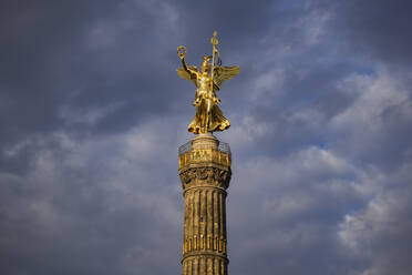 Germany, Berlin, Victory Column standing against cloudy sky - ABOF00748