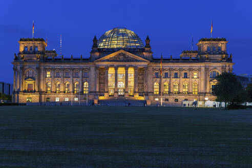 Germany, Berlin, Illuminated facade of Reichstag at night - ABOF00753