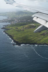 Scenic view of airplane over island - AFVF09240