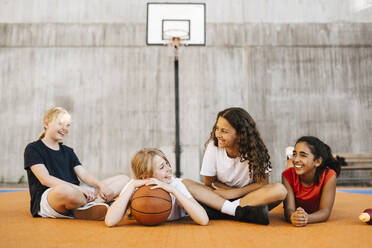 Lächelnde multiethnische Freundinnen verbringen ihre Freizeit auf dem Basketballplatz - MASF26046