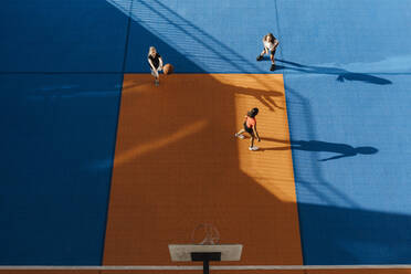 Directly above shot of girls playing basketball at sports court - MASF26056