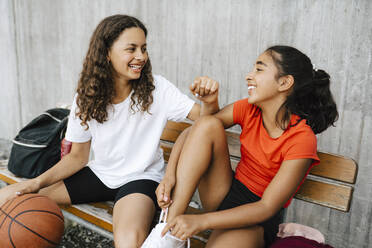 Happy girls spending leisure time at basketball court - MASF26064