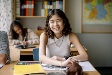 Portrait of teenage girl in junior high classroom - MASF26315